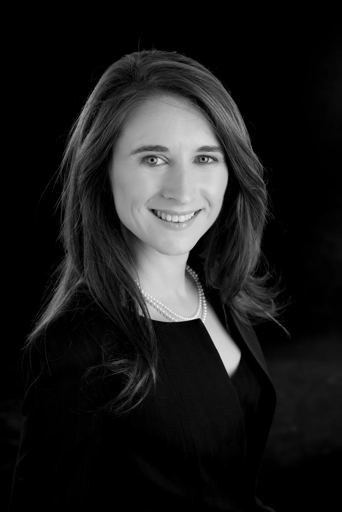 Studio headshot of a businesswoman on a black background