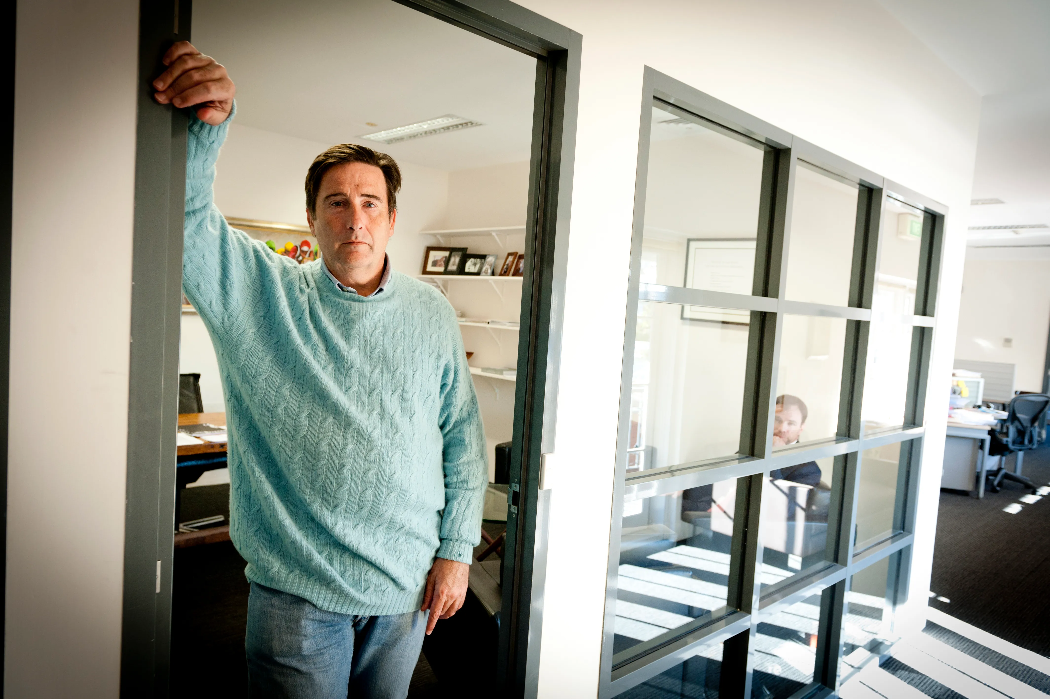 An investor photographed in the doorway of his office