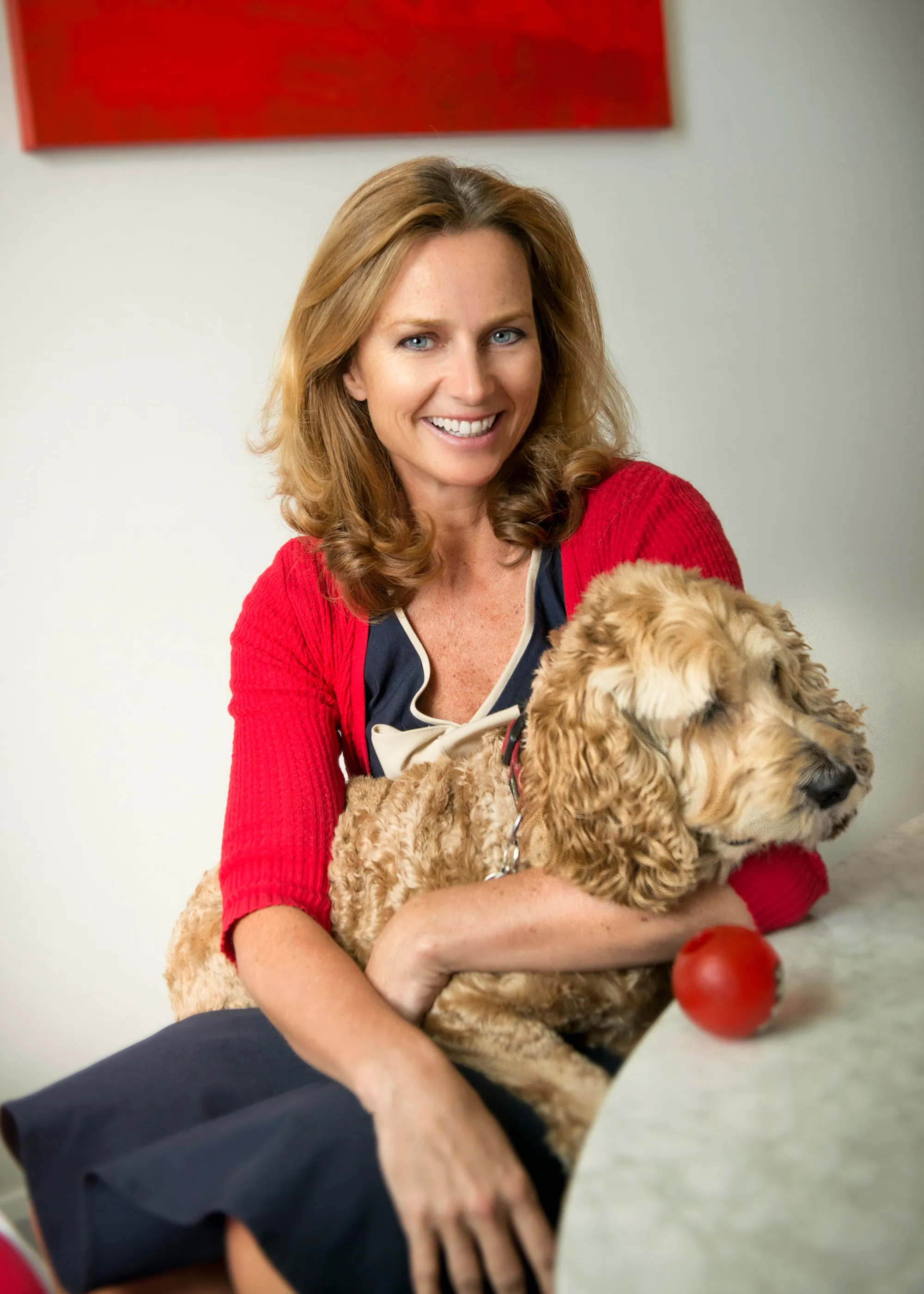 A business founder photographed at home with her dog