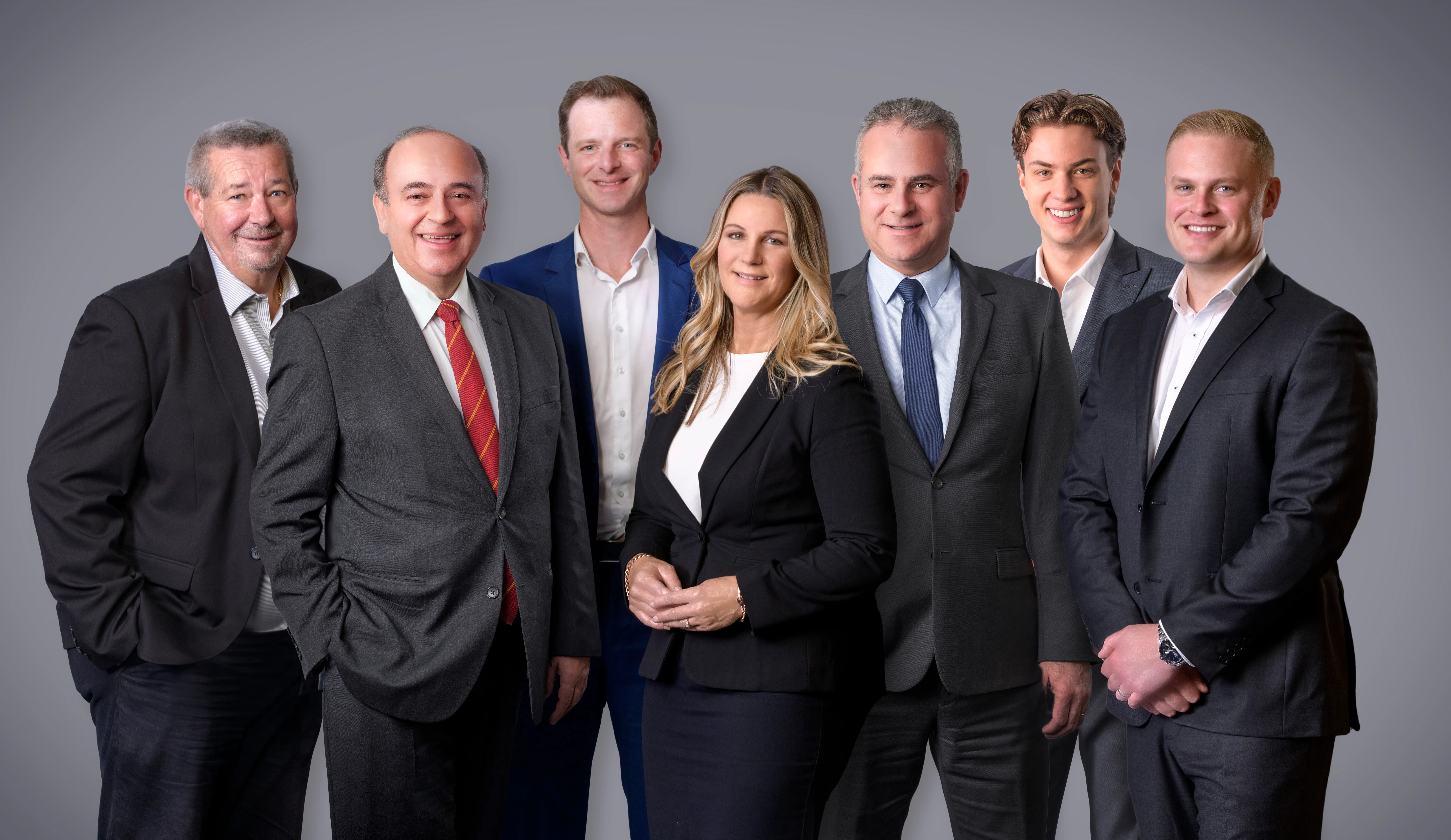 A full corporate team photographed to one consistent look in a single on-site session